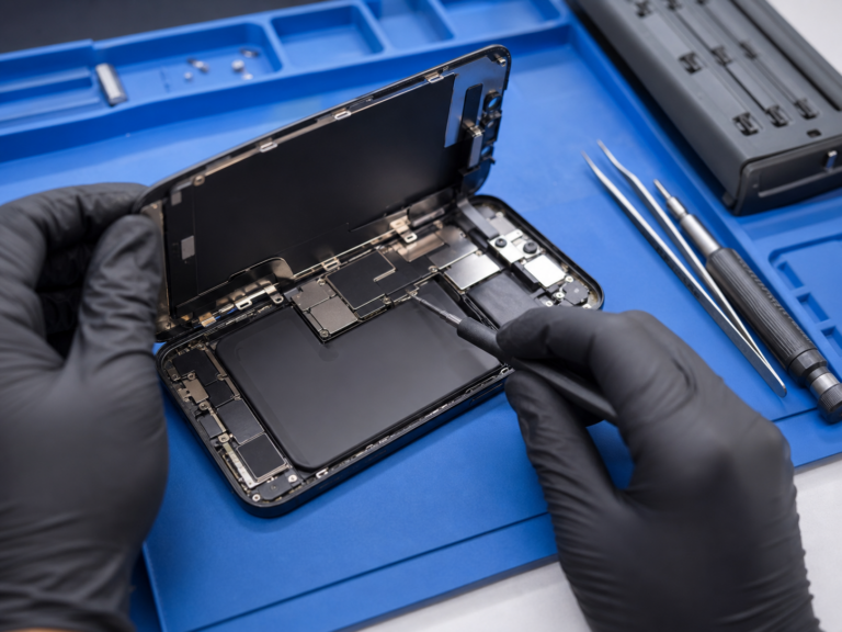 Phone repair Lima OH — technician repairing an open iPhone