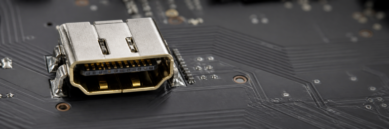 Close-up of a repaired HDMI port on a console circuit board