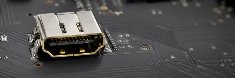 Close-up of a repaired HDMI port on a console circuit board